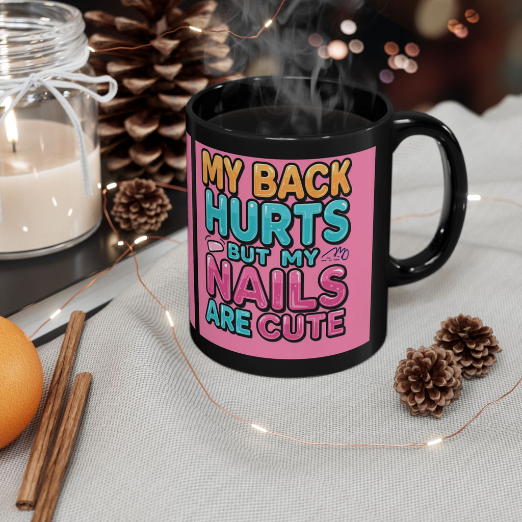 Black mug with colorful text on a table with decorative items