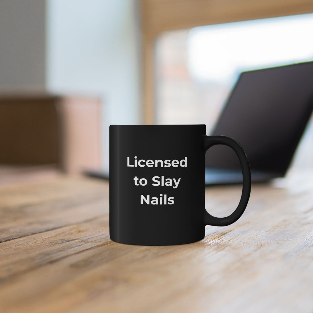 Black mug with library-themed design on a wooden surface