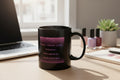 Black mug with purple text on a white background