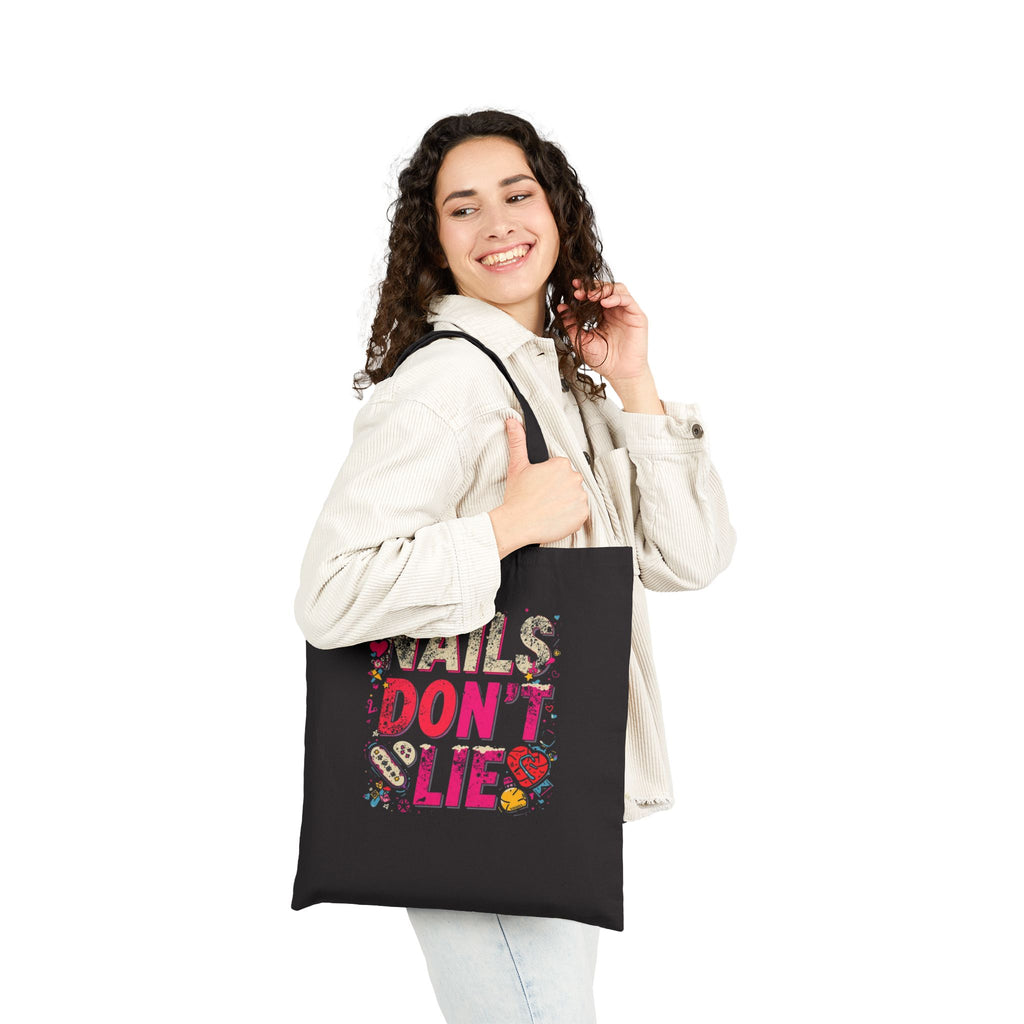 Woman holding a black tote bag with a pumpkin design and text on a white background