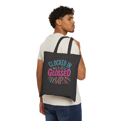 Person wearing a black tote bag with colorful text 'TEACH! LAUGH, REPEAT' on a white background