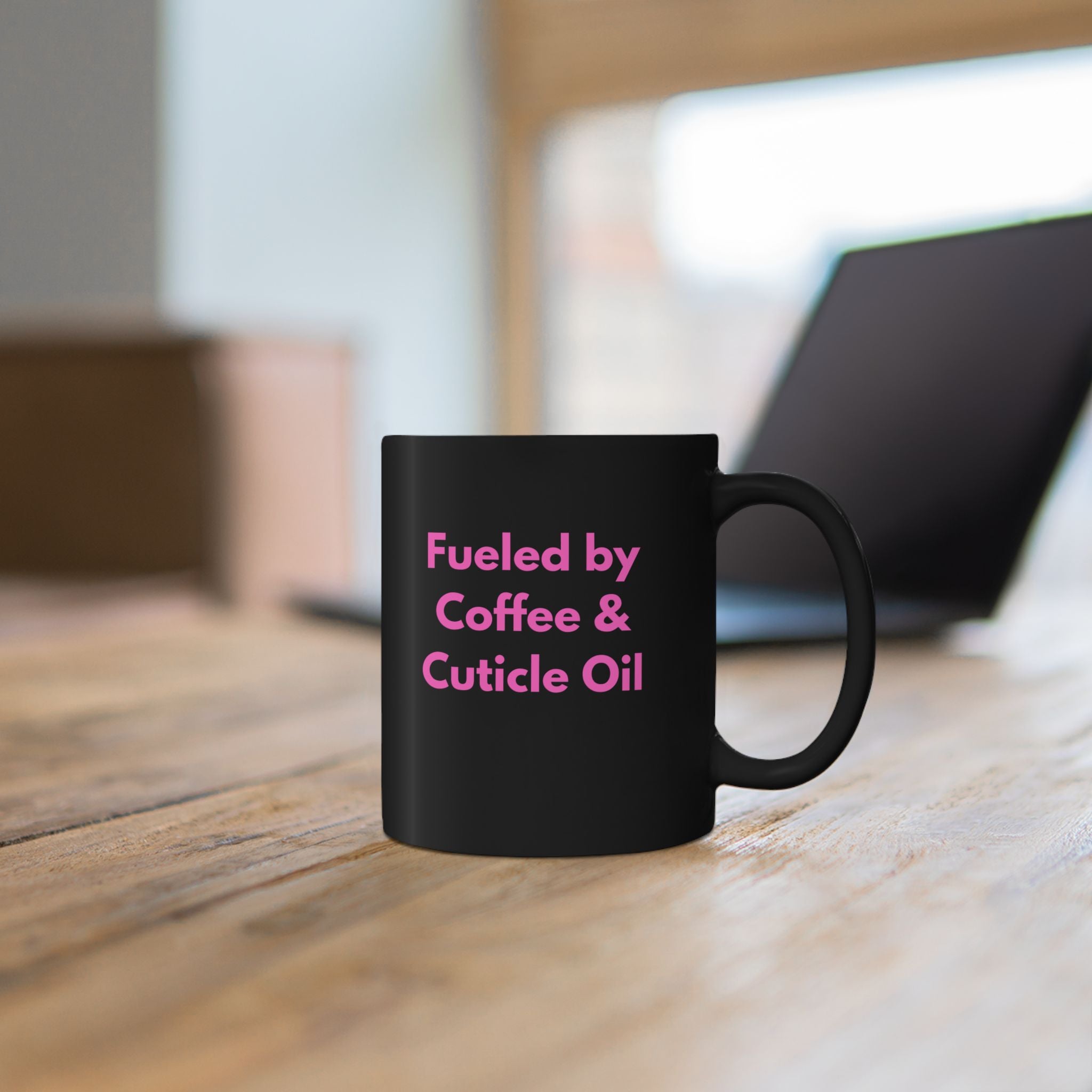 Black mug with white map design on a wooden surface