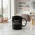 Black mug with white graphic design on a white background