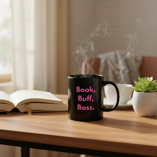 Black mug with pink text 'Book, Buff, Boss.' on a white background