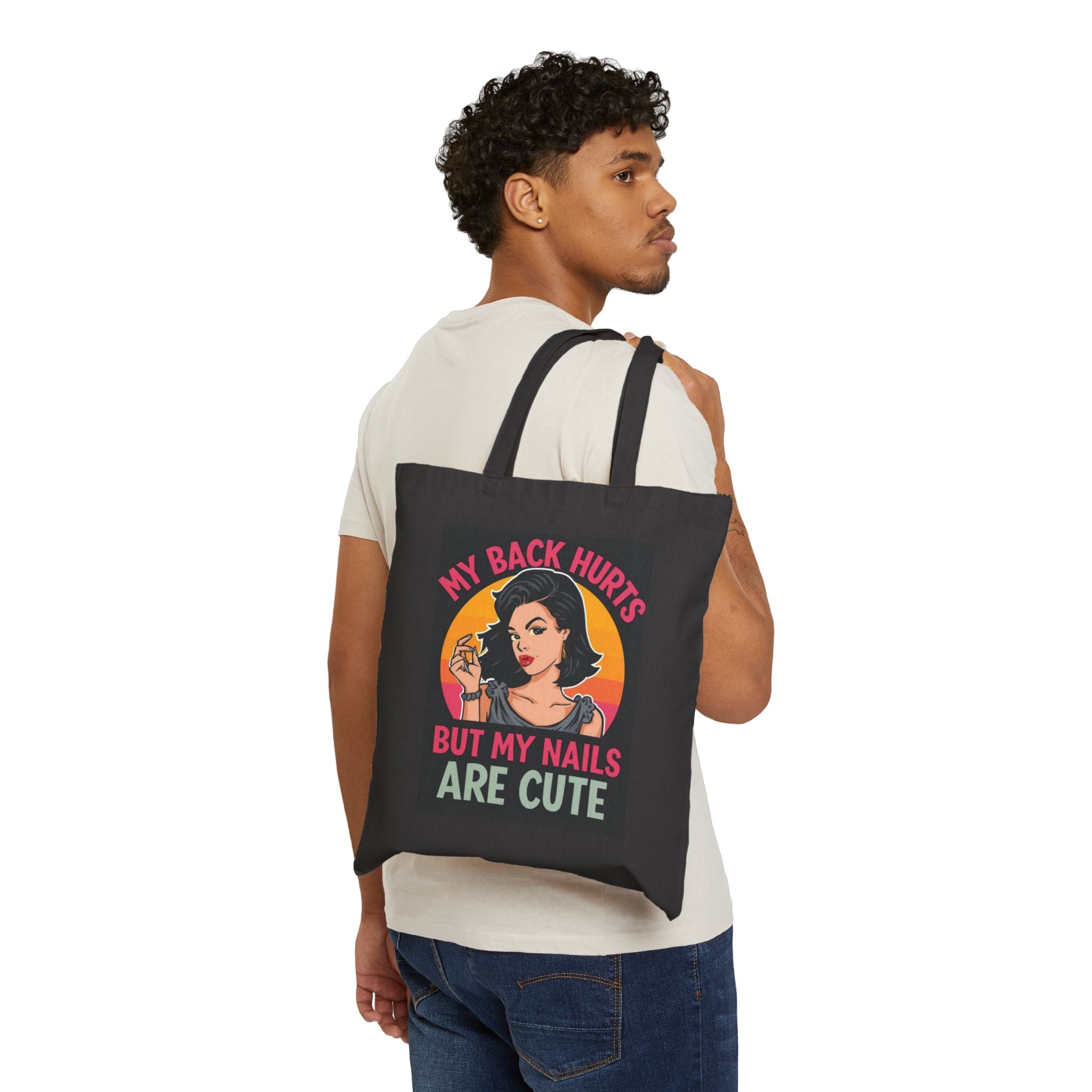Person wearing a black tote bag with a colorful apple design and 'Chaos Coordinator' text.