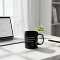 Black mug with white text on a white background