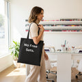 Black tote bag with 'No Free Sets.' text on a white background