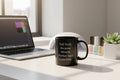 Black mug with white text on a white background