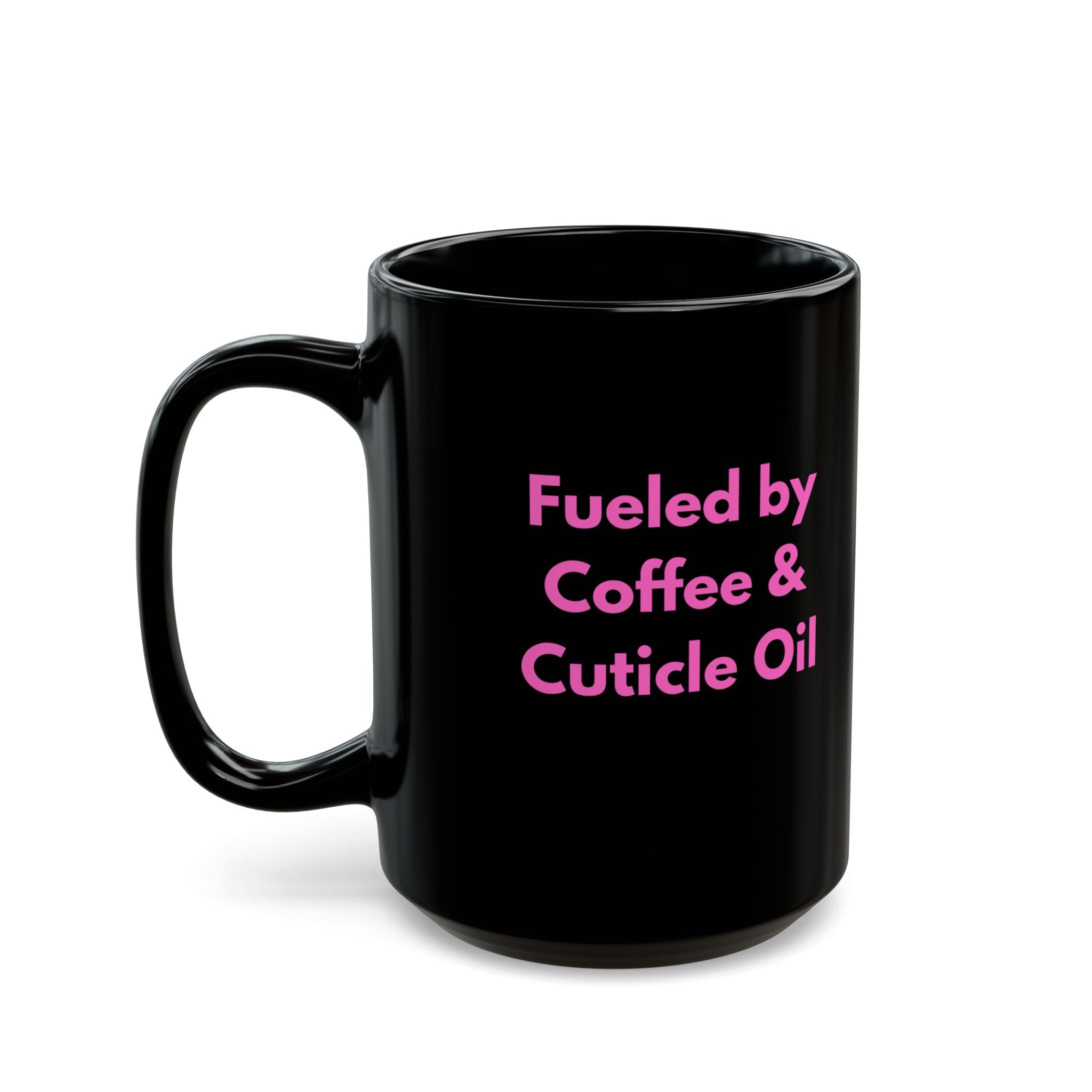 Black mug with pink text 'Fueled by Coffee & Cuticle Oil' on a white background