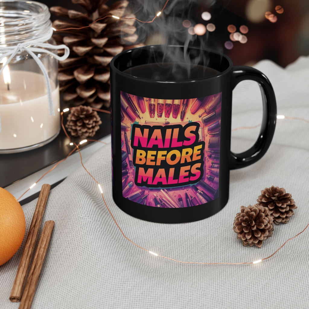 Black mug with 'Nails Before Males' design on a table with decorative items.