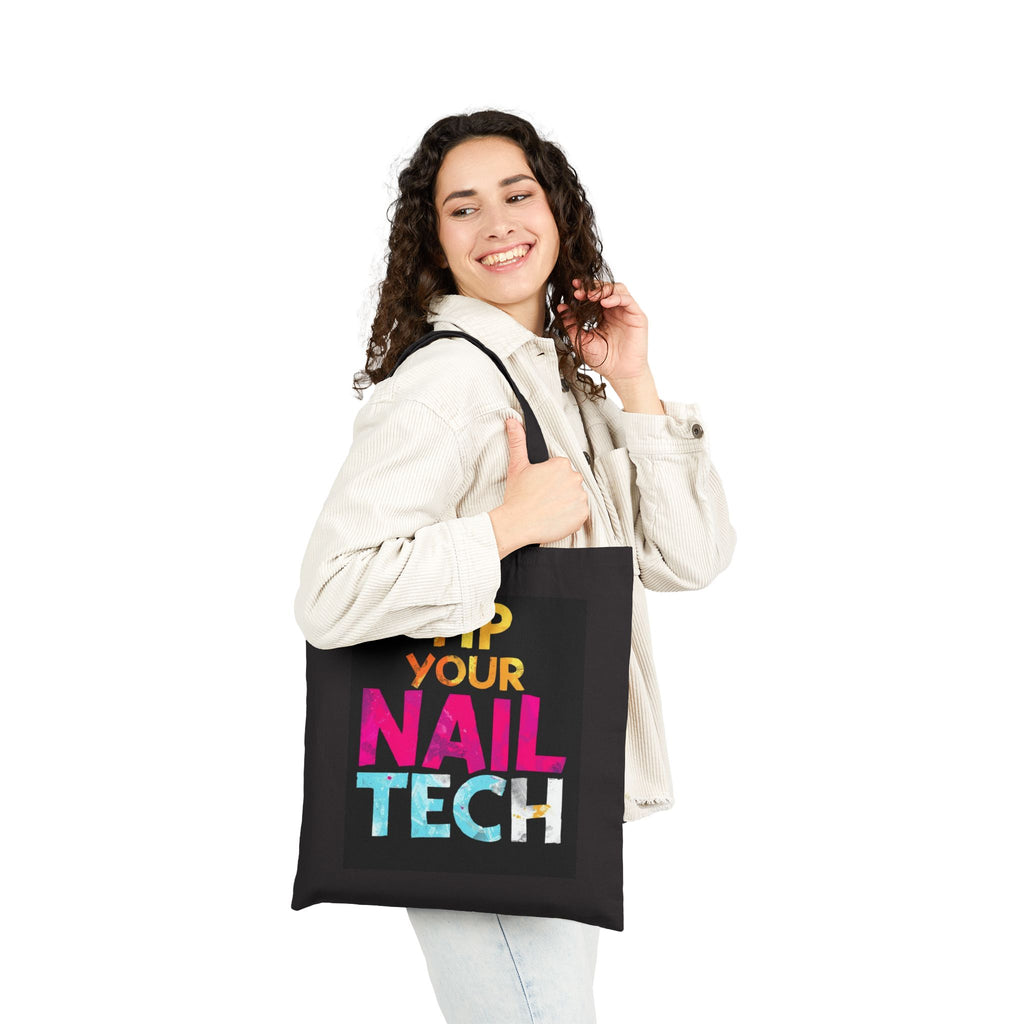 Woman holding a black tote bag with colorful text on a white background