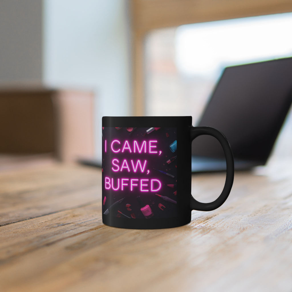 Black mug with pink text 'I CAME, SAW, BUFFED' on a wooden surface.