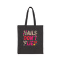 Black tote bag with colorful 'Nails Don't Lie' text design on a white background