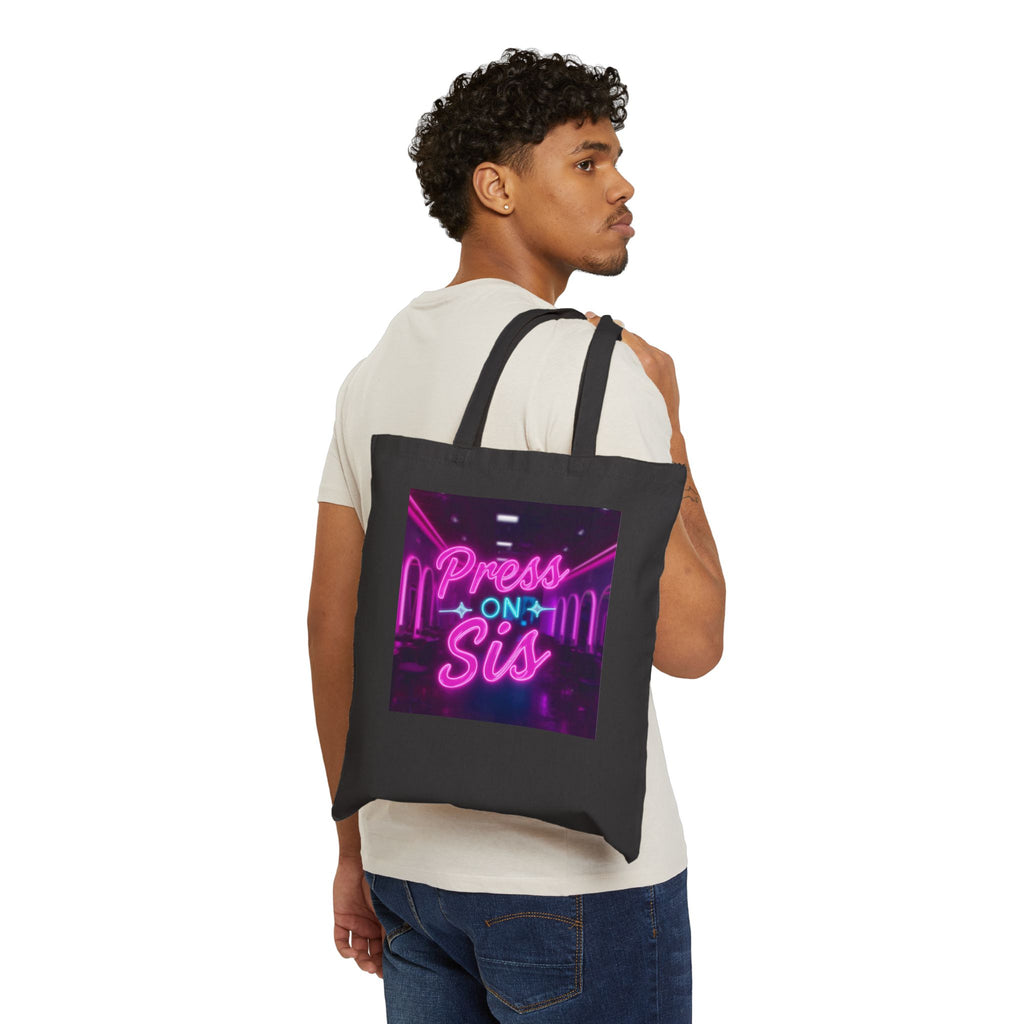 Man carrying a black tote bag with 'Press On Sis' neon design.