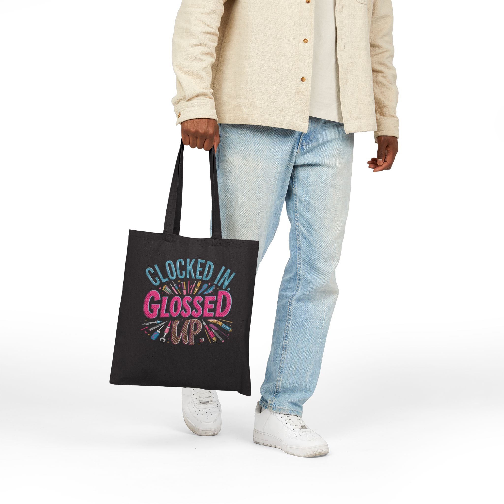 Person holding a black tote bag with a humorous tech support graphic and text.